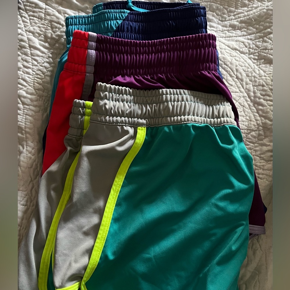 3 pairs of Nike running shorts, 2 L, 1 M